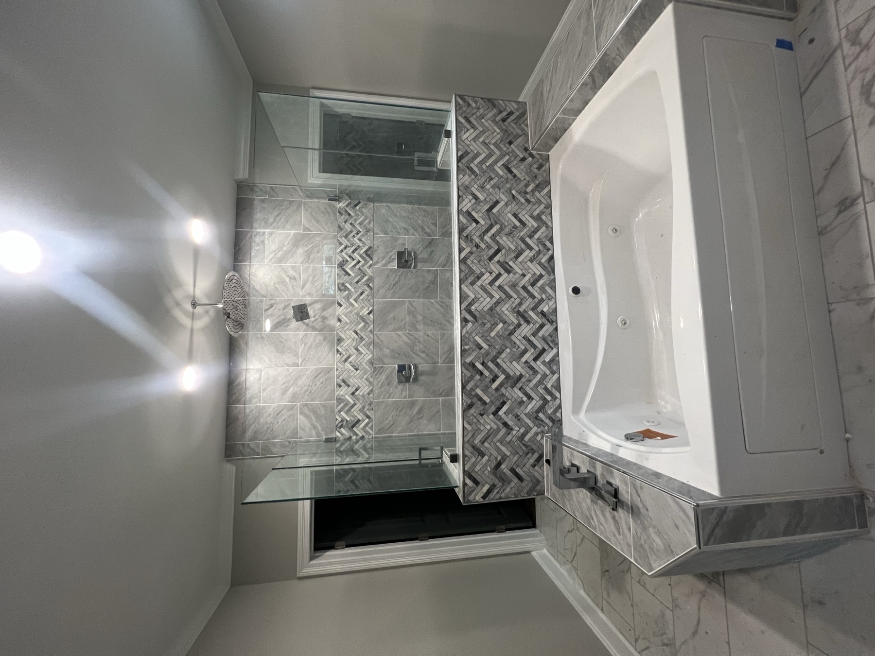 Full bathroom remodel with marble tile shower and jacuzzi tub by Pipe It Up Plumbing