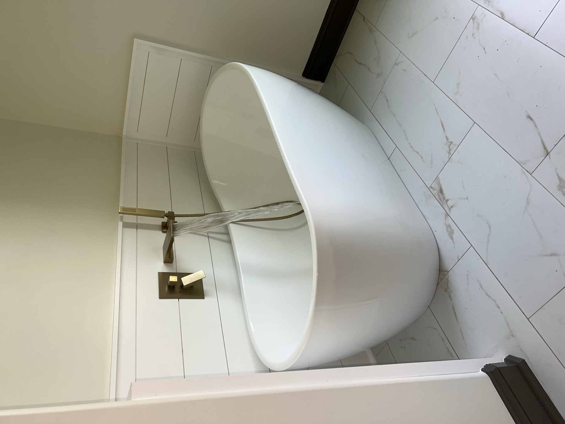 Freestanding tub install with brushed gold fixtures